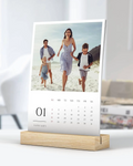 Calendar with a family photo on a stand against a white background