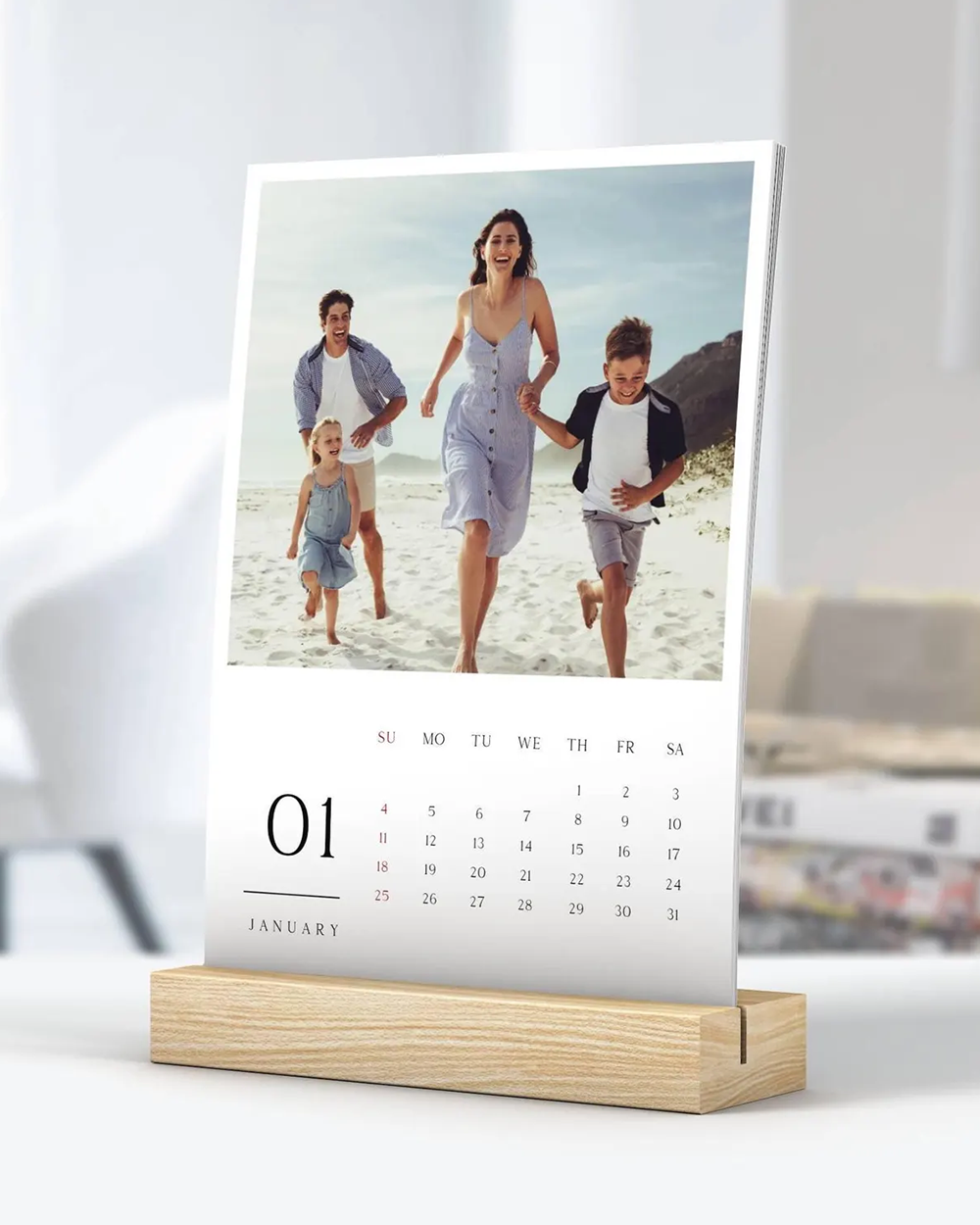 Calendar with a family photo on a stand against a white background