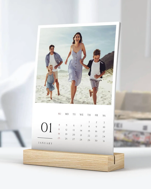 Calendar with a family photo on a stand against a white background