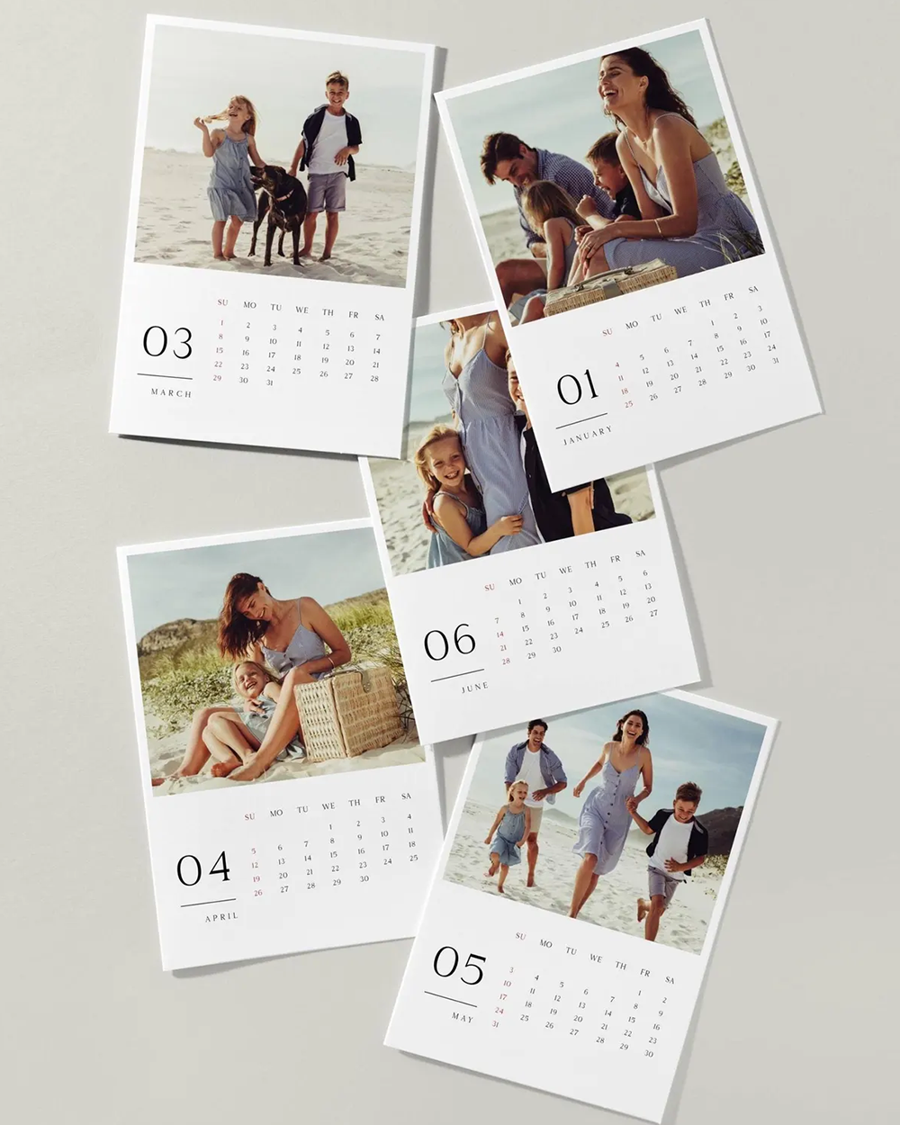 Collection of photo calendars with family pictures on a light gray background