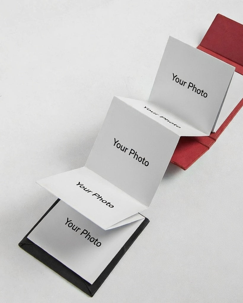 Red photo album with white pages labeled 'Your Photo' on a light gray background