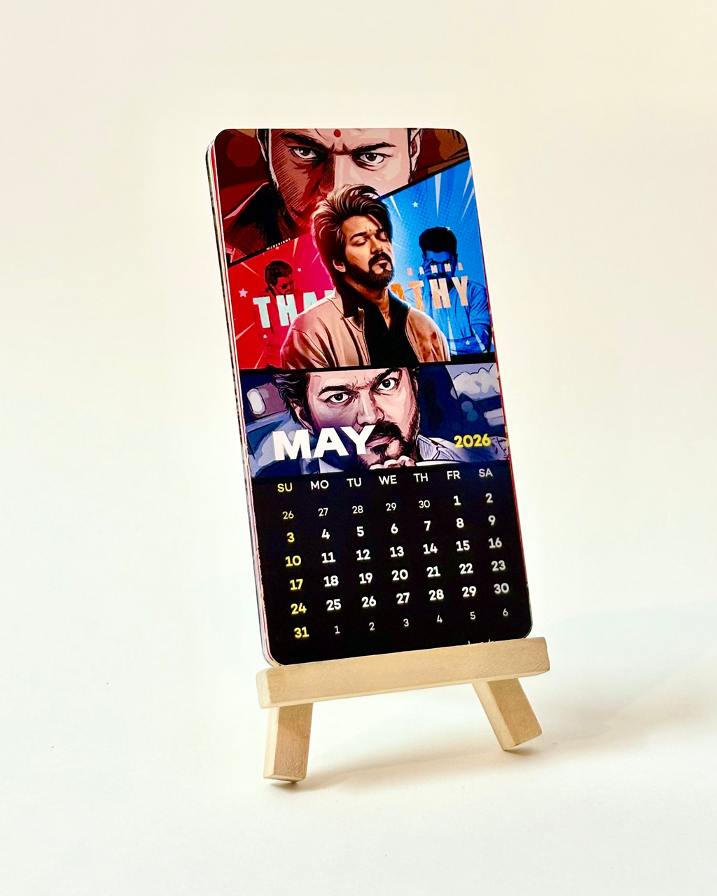Calendar with movie-themed cover on a stand against a light background
