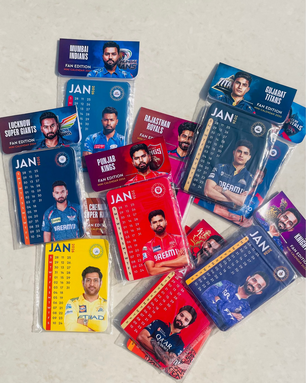 Collection of sports trading cards featuring various players in different teams on a light gray background.