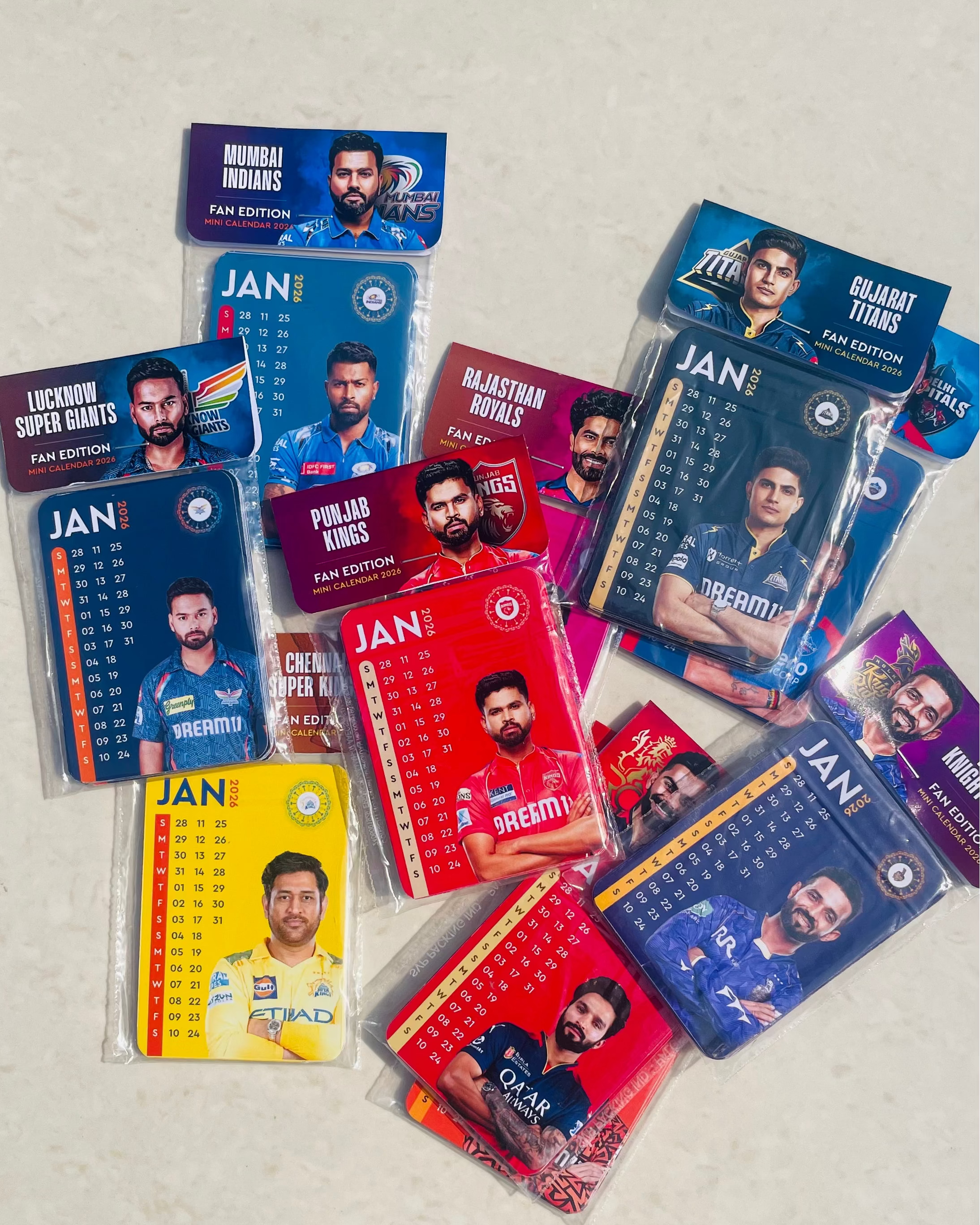 Collection of sports trading cards featuring various players in different teams on a light gray background.