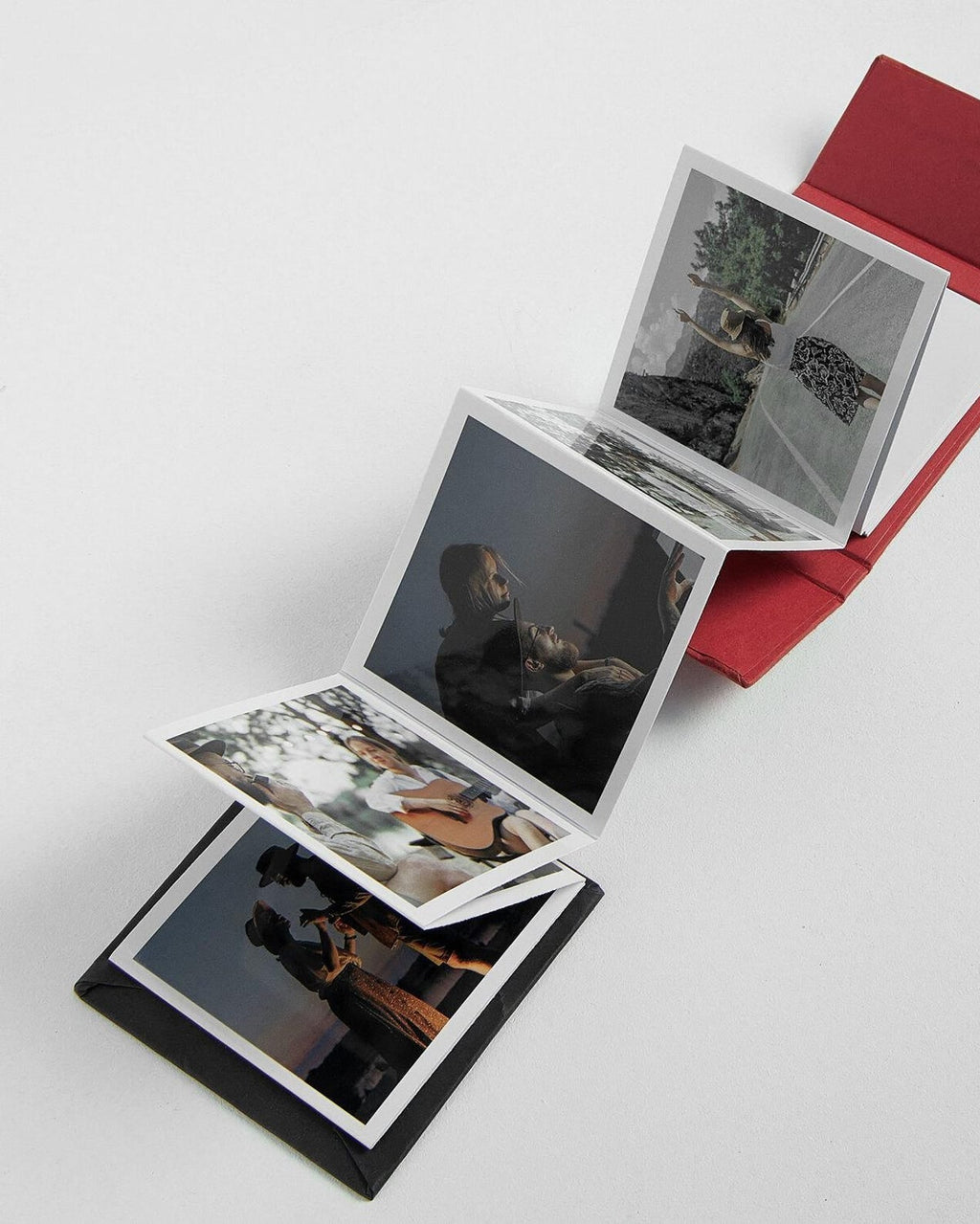 Stack of photo albums with images on a white background