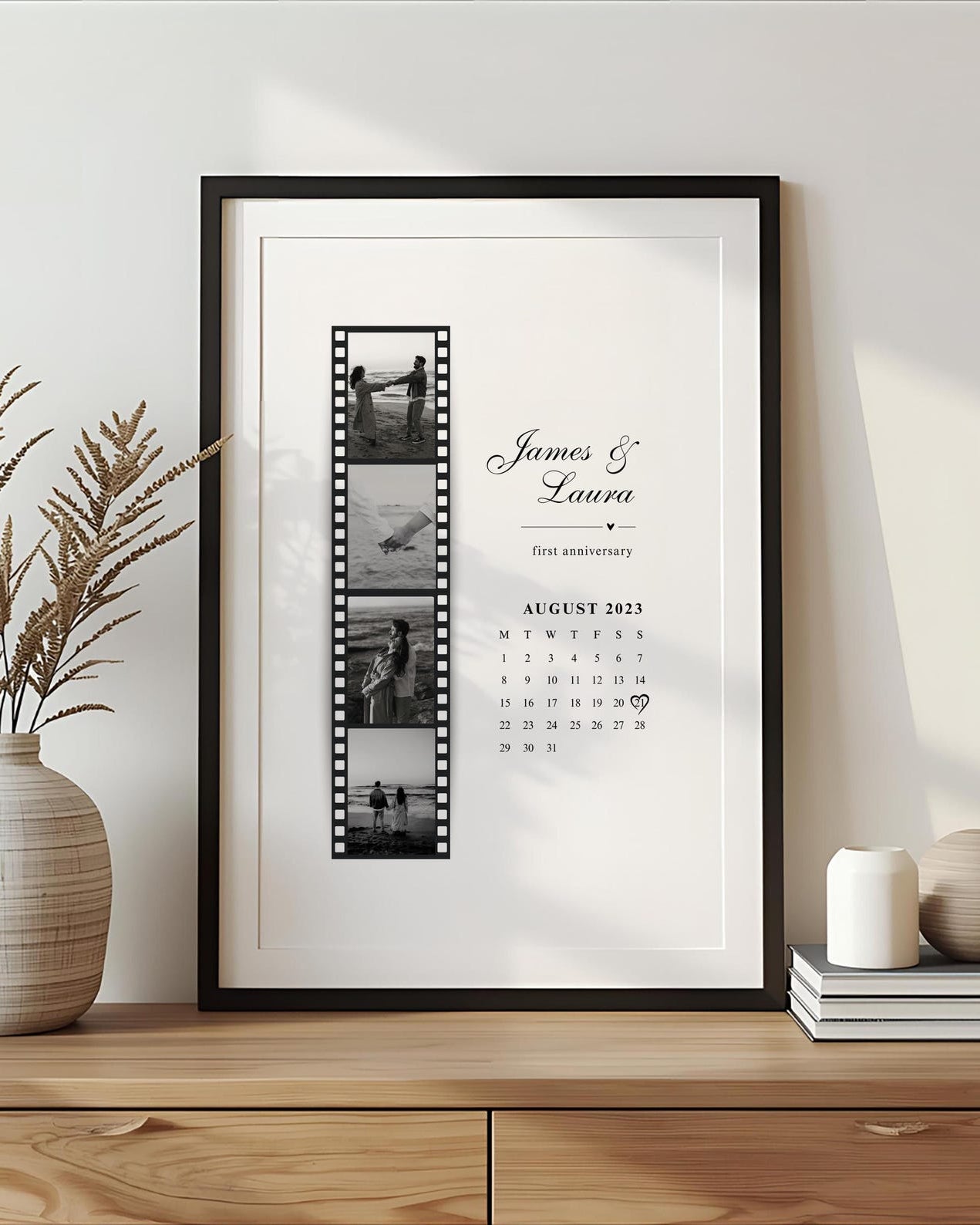 Framed artwork with calendar and photos on a wooden shelf with decorative items.