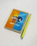 Notebook with Naruto and Sasuke design and a yellow pen on a white background