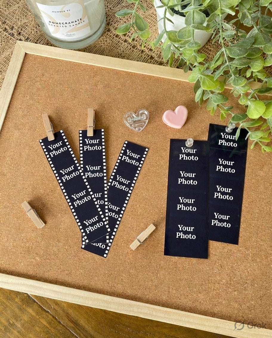 Navy blue photo holders with text on a cork board with decorative items.
