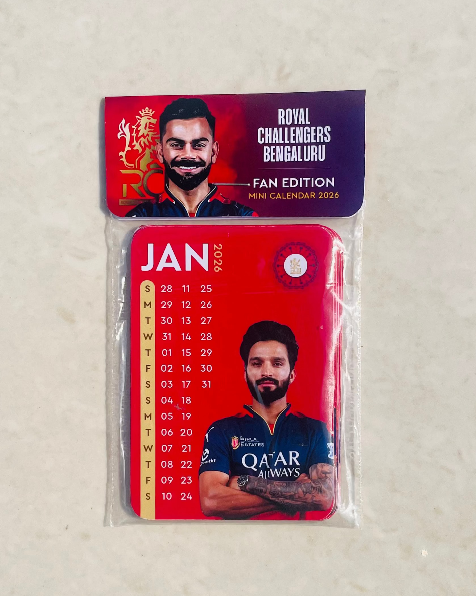 Packaged product with a red label featuring a person's face on a light gray background