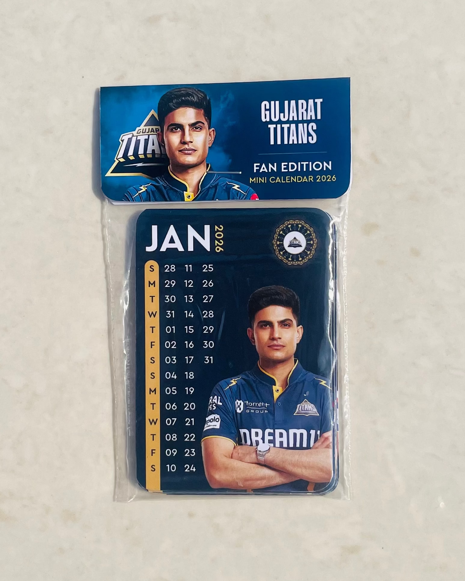 Gujarat Titans calendar with player image on a beige background