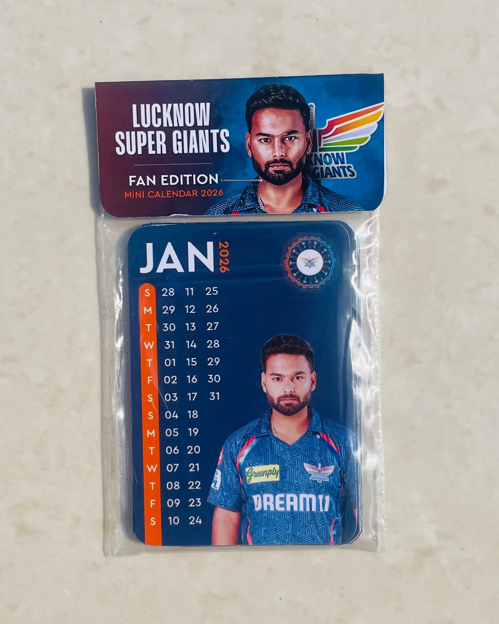 Calendar with Lucknow Super Giants branding on a textured beige background