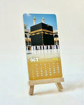 Calendar with a picture of the Kaaba on a stand against a light background
