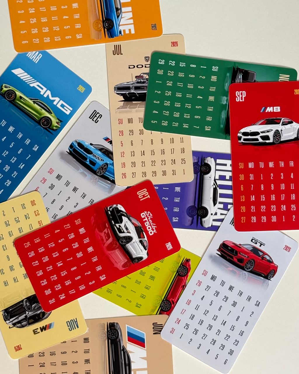 Collection of car-themed calendars on a light background