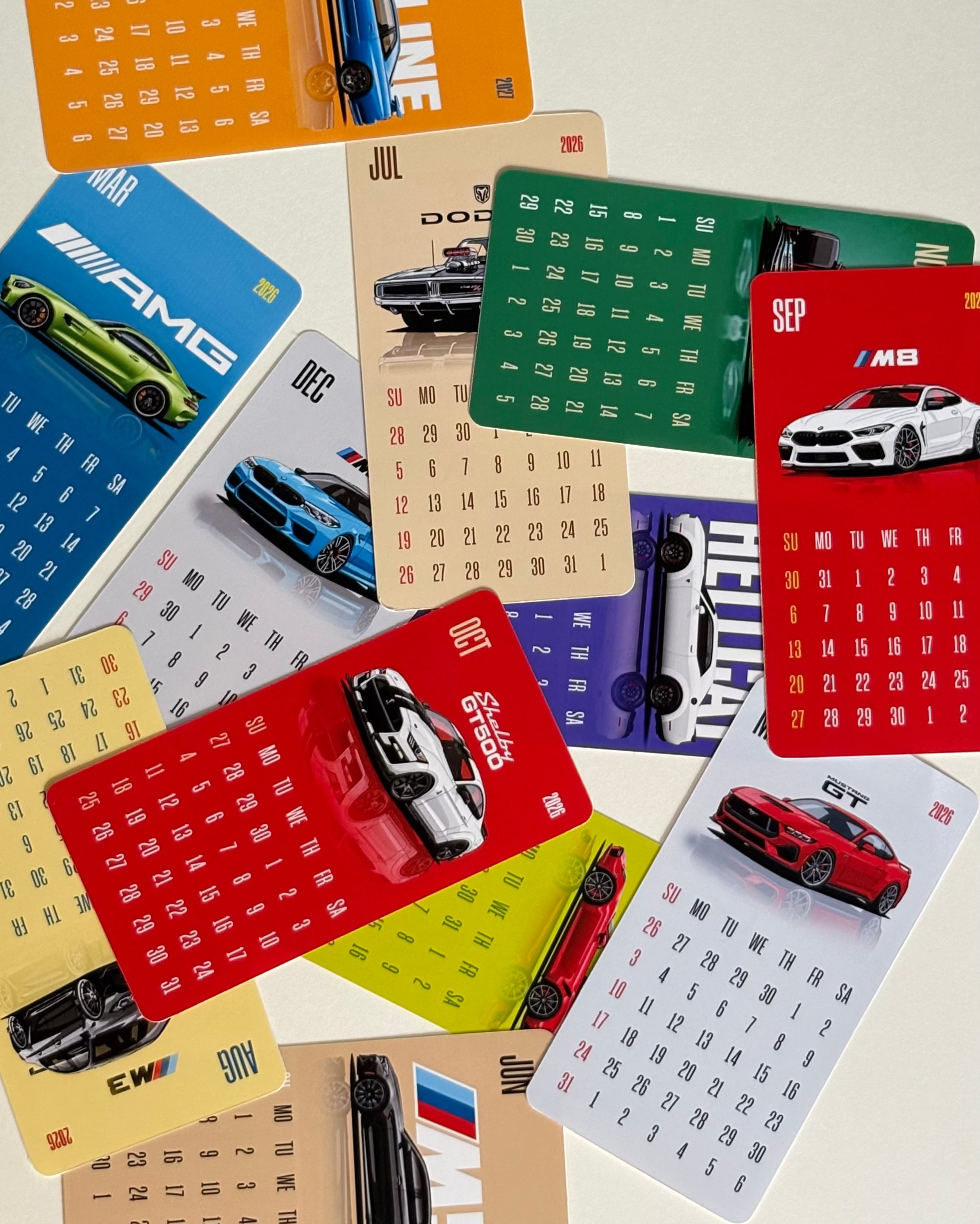 Collection of car-themed calendars on a light background