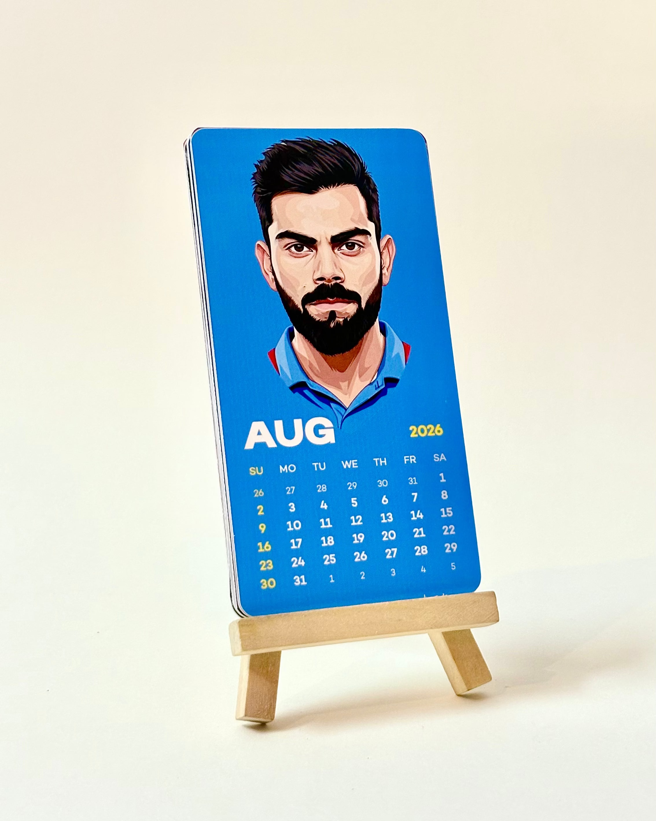 Calendar with a portrait of a person on a blue background, displayed on a small easel.